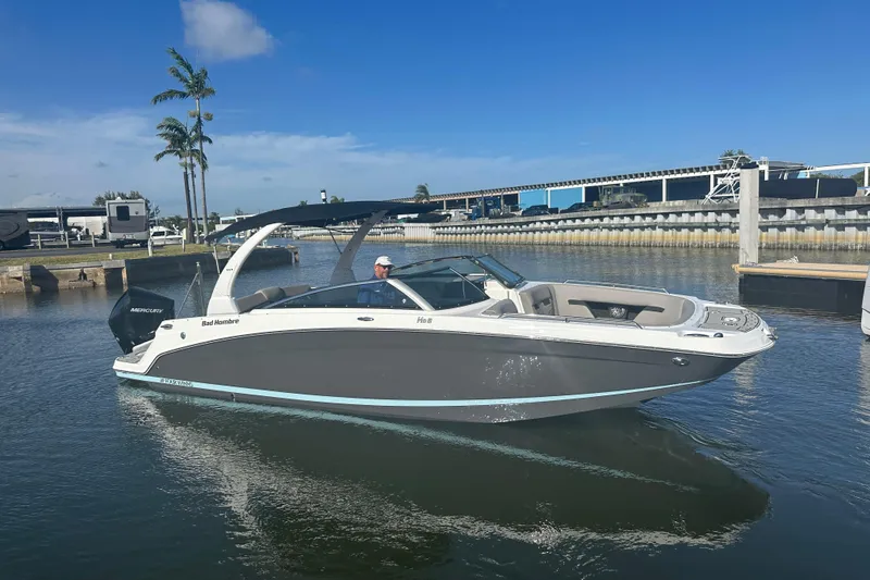 Slide: The Image of 2022 Four Winns HD8 OB boat on calm water, clear sky background. - 5