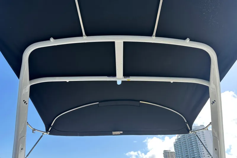 Slide: The Image of 2022 Four Winns HD8 OB boat canopy against blue sky and cityscape. - 51