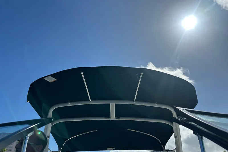 Slide: The Image of 2022 Four Winns HD8 OB boat canopy under bright sun. - 52