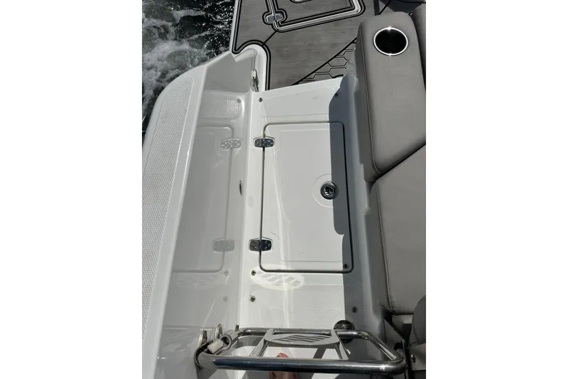 Slide: The Image of 2022 Four Winns HD8 OB boat interior with storage compartment and seating. - 53