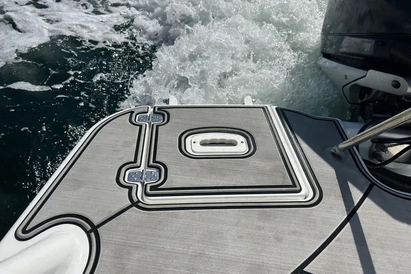 Slide: The Image of 2022 Four Winns HD8 OB boat deck with water splashing behind. - 56