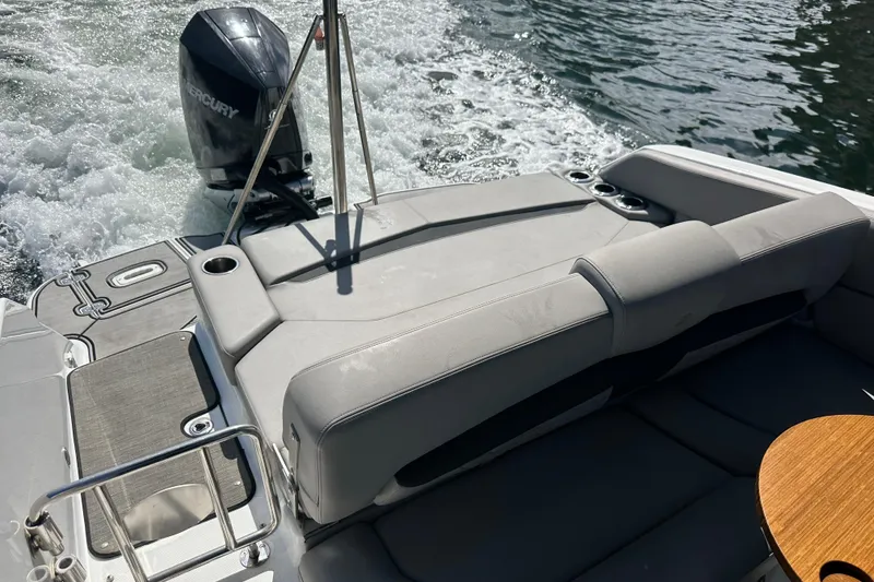 Slide: The Image of 2022 Four Winns HD8 OB boat with Mercury outboard motor on water. - 58
