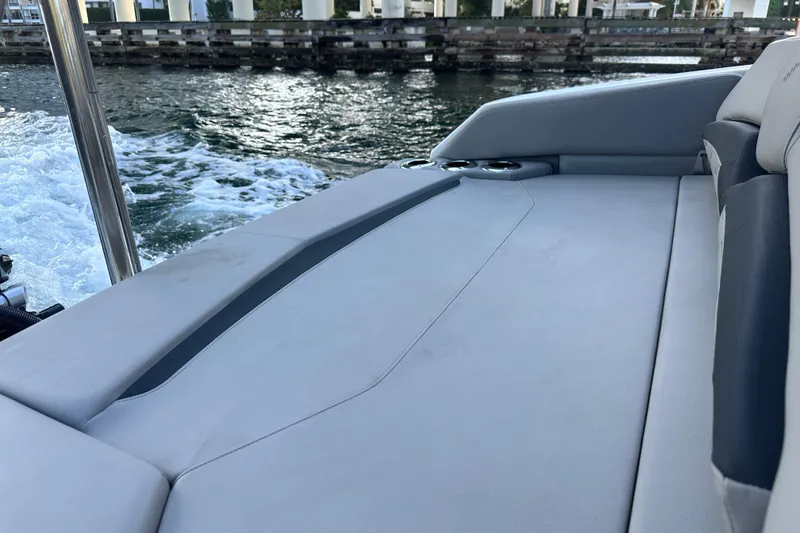 Slide: The Image of 2022 Four Winns HD8 OB boat interior with cushioned seating and water view. - 59