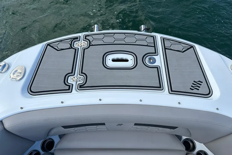 Slide: The Image of 2022 Four Winns HD8 OB boat deck with sleek design and water backdrop. - 6