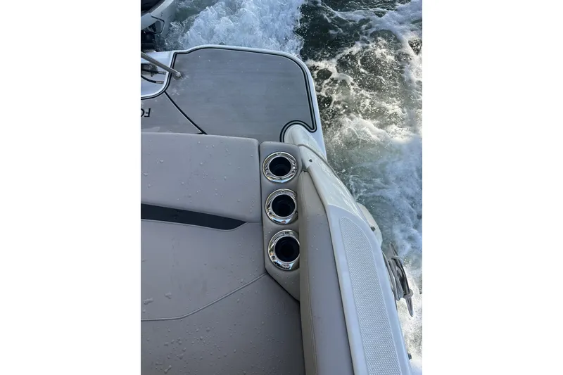 Slide: The Image of 2022 Four Winns HD8 OB boat stern with cup holders and water wake. - 62