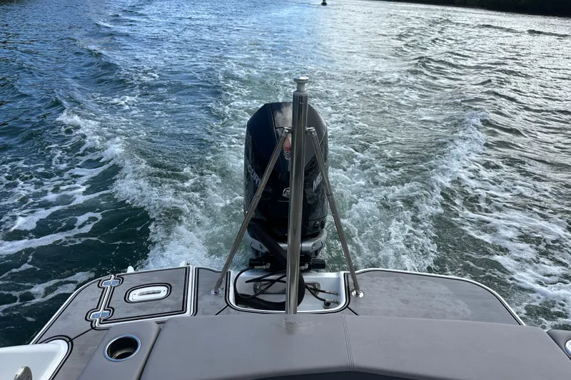 Slide: The Image of 2022 Four Winns HD8 OB boat cruising on water, rear view with outboard motor. - 63