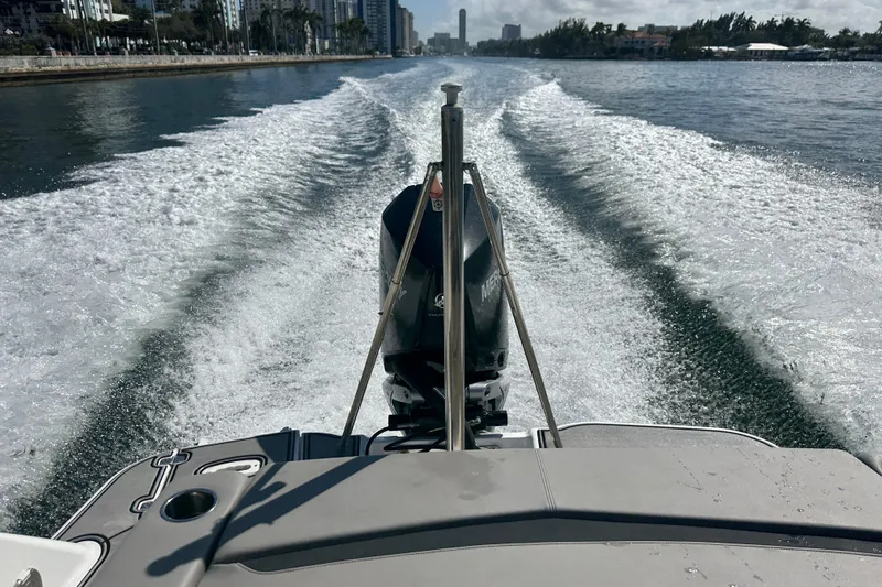 Slide: The Image of 2022 Four Winns HD8 OB boat cruising on a sunny waterway, leaving a wake. - 64