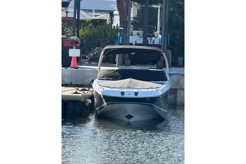 Slide: The Image of 2022 Four Winns HD8 OB boat docked at marina, front view. - 68