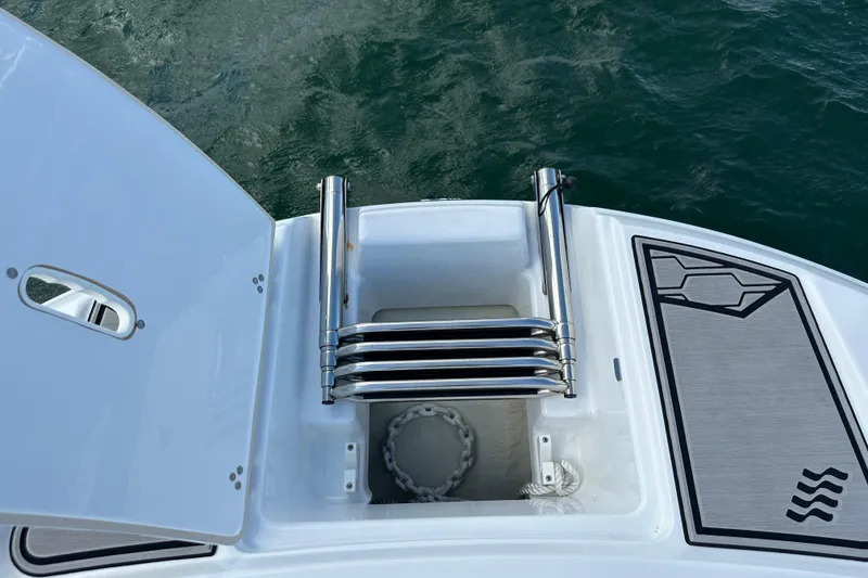 Slide: The Image of 2022 Four Winns HD8 OB boat ladder and storage compartment on deck. - 7