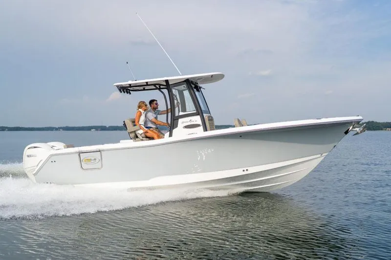 Slide: The Image of Manufacturer Provided Image: 2026 Sea Hunt Gamefish 25 cruising on water, side view, two people onboard. - 27