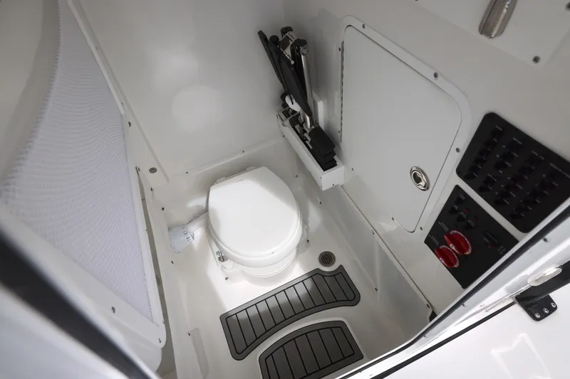 Slide: The Image of Interior of 2026 Sea Hunt Gamefish 25 with toilet and controls. - 9