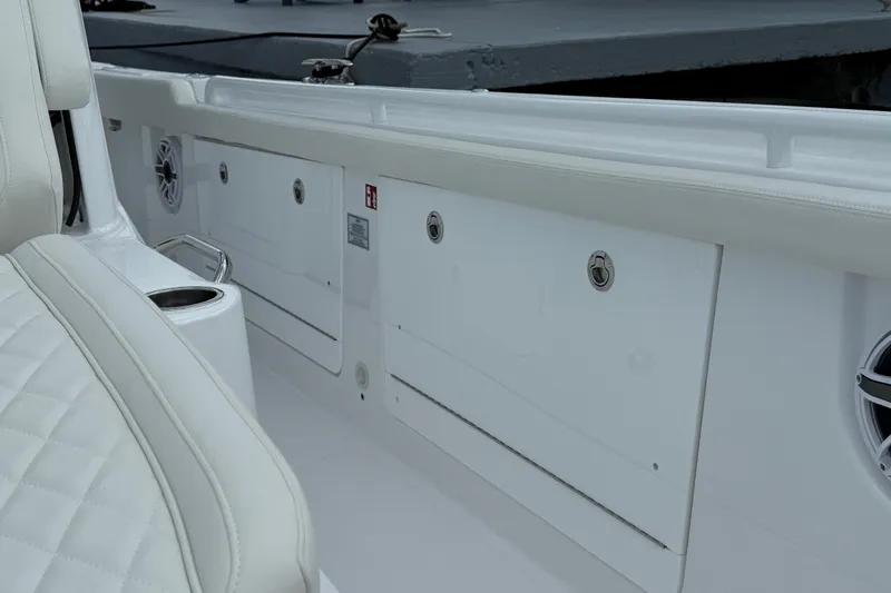 Slide: The Image of 2026 Everglades 315 Center Console interior with white seating and storage compartments. - 11
