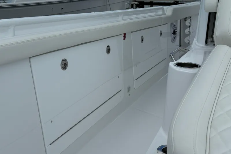 Slide: The Image of 2026 Everglades 315 Center Console interior with storage compartments and seating. - 12