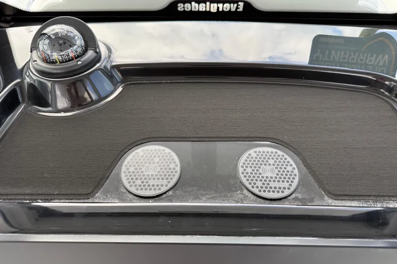 Slide: The Image of 2026 Everglades 315 Center Console dashboard with compass and wireless charging pad. - 16