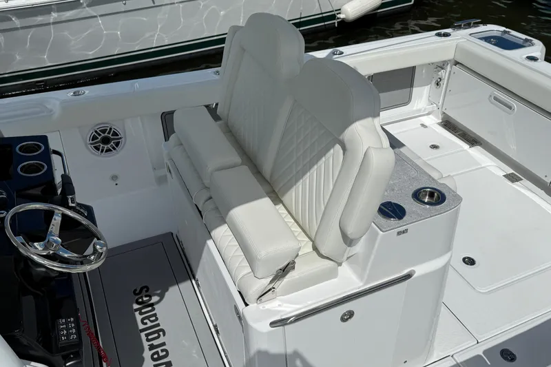 Slide: The Image of 2026 Everglades 315 Center Console boat interior with white seating and steering wheel. - 17