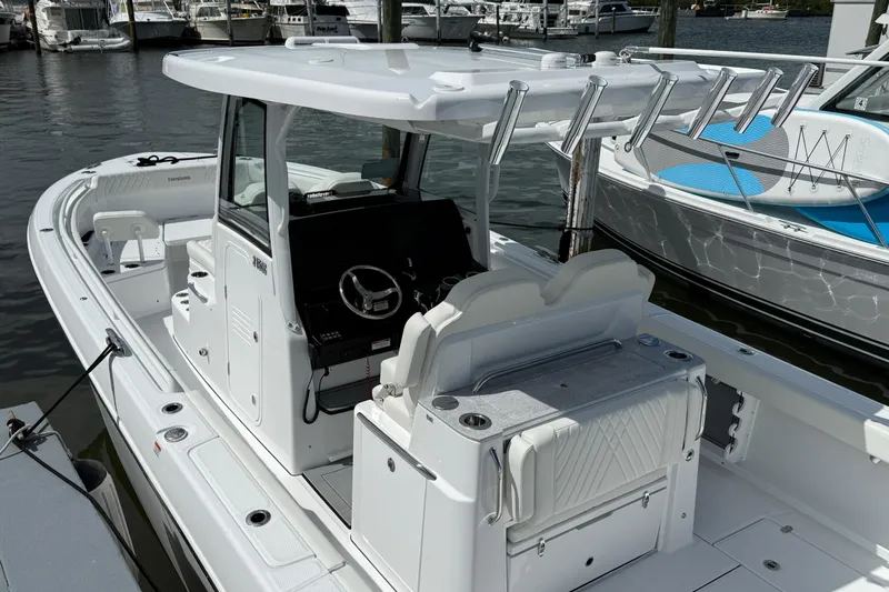 Slide: The Image of 2026 Everglades 315 Center Console boat docked, featuring sleek design and modern amenities. - 19