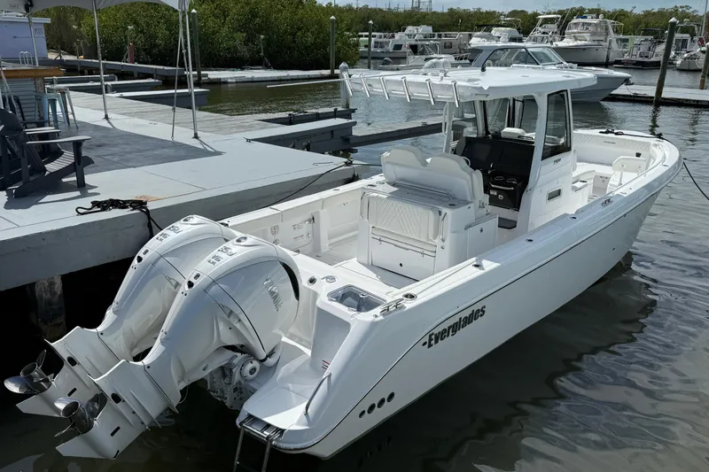 Slide: The Image of 2026 Everglades 315 Center Console boat docked with dual engines, sleek design. - 2
