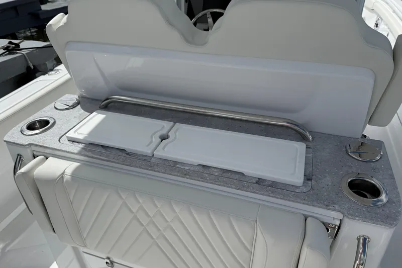 Slide: The Image of 2026 Everglades 315 Center Console boat interior with luxury seating and built-in cup holders. - 24