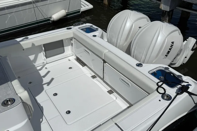 Slide: The Image of 2026 Everglades 315 Center Console boat with dual Yamaha engines, docked in marina. - 25
