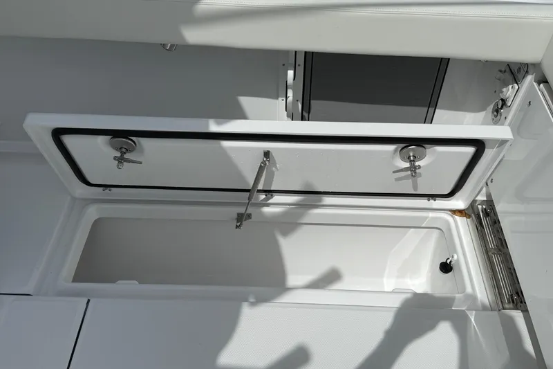 Slide: The Image of Open storage compartment on 2026 Everglades 315 Center Console boat. - 26