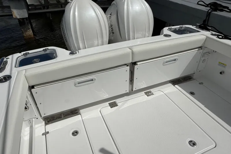 Slide: The Image of 2026 Everglades 315 Center Console boat interior with storage compartments and seating. - 27