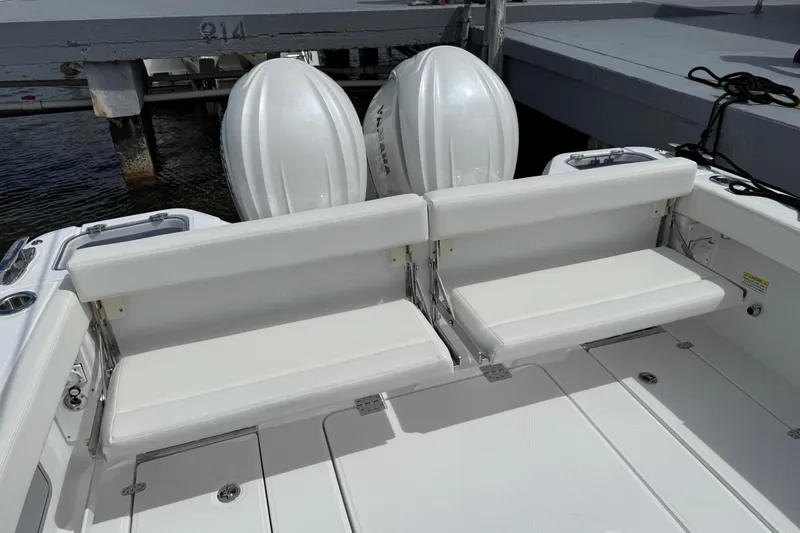 Slide: The Image of 2026 Everglades 315 Center Console boat with dual outboard engines and white seating. - 28