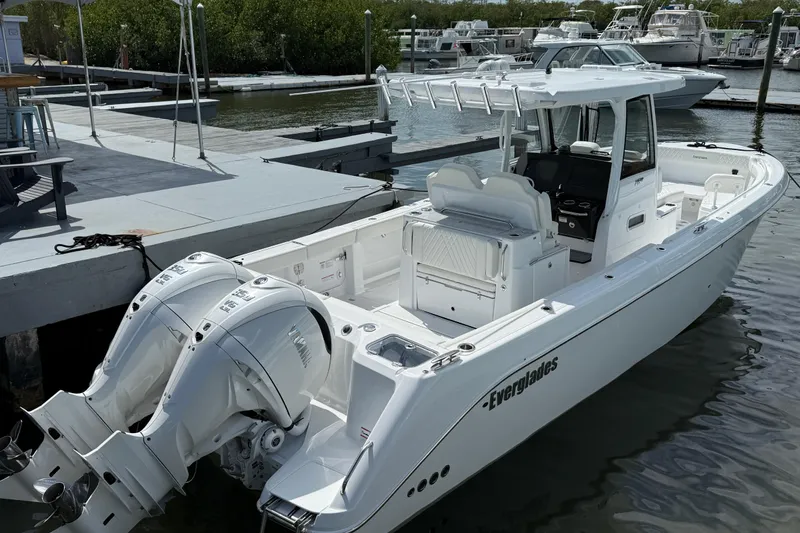 Slide: The Image of 2026 Everglades 315 Center Console boat docked, featuring dual outboard engines. - 3
