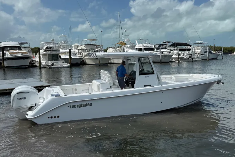 Slide: The Image of 2026 Everglades 315 Center Console boat docked in marina with Yamaha engine. - 30