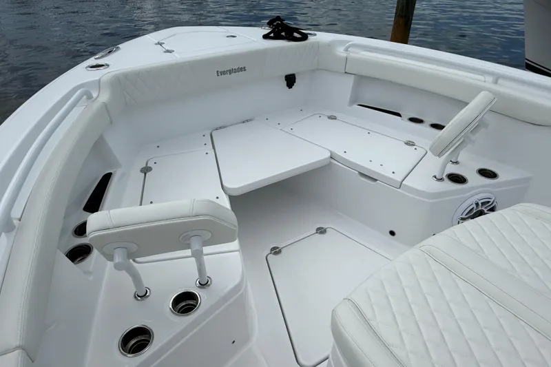 Slide: The Image of 2026 Everglades 315 Center Console boat interior with white seating and cup holders. - 4