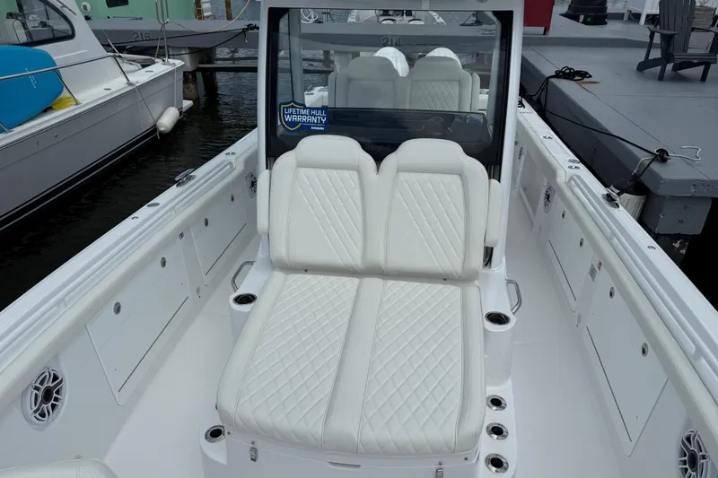 Slide: The Image of 2026 Everglades 315 Center Console boat with white seating and lifetime hull warranty. - 5