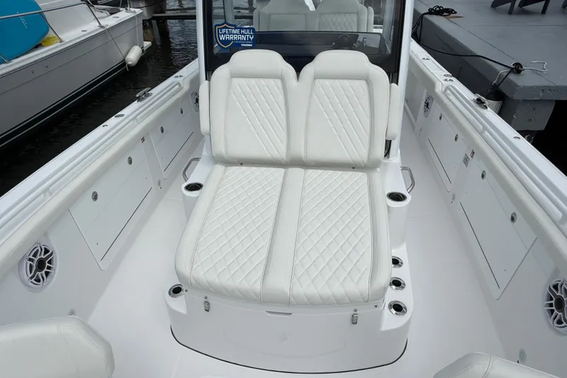 Slide: The Image of 2026 Everglades 315 Center Console boat with luxurious white seating and cup holders. - 6