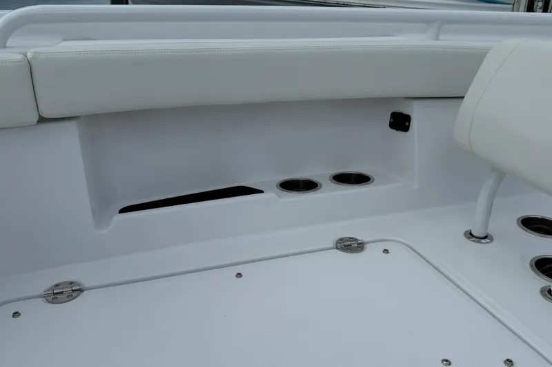 Slide: The Image of 2026 Everglades 315 Center Console boat interior with cup holders and seating. - 7