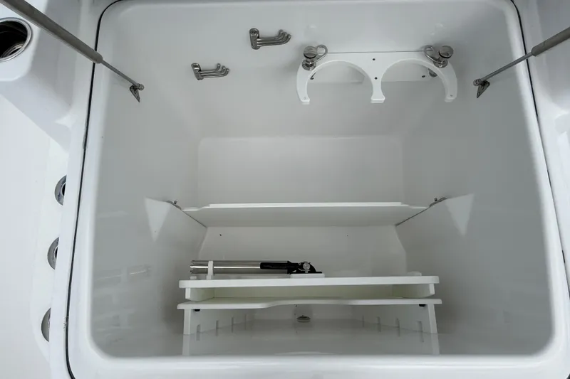 Slide: The Image of Storage compartment of 2026 Everglades 315 Center Console boat, featuring organized shelving. - 8