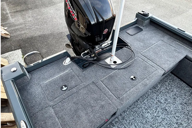 Slide: The Image of 2026 Ranger VS1782SC Reata boat deck with motor, featuring gray carpeted surface. - 12