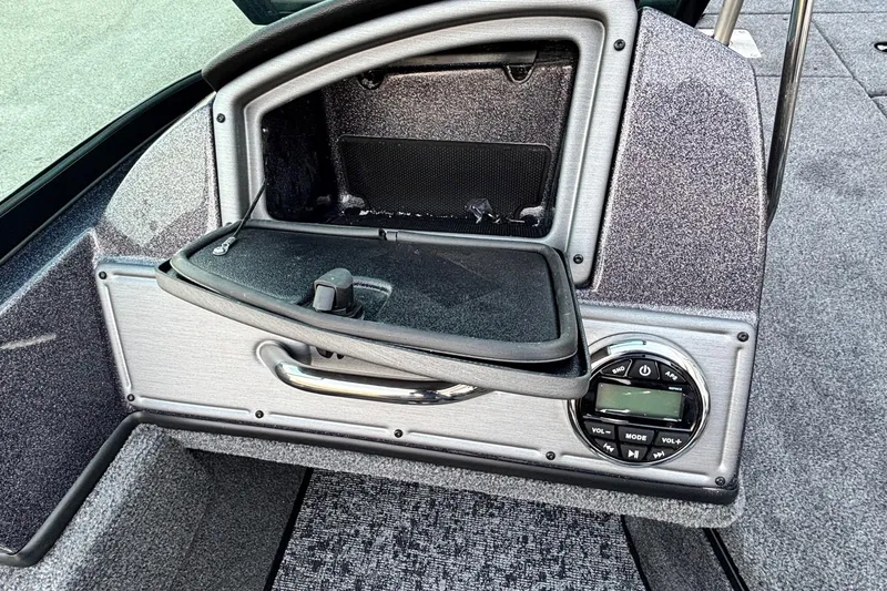 Slide: The Image of 2026 Ranger VS1782SC Reata boat dashboard with open storage compartment and control panel. - 7