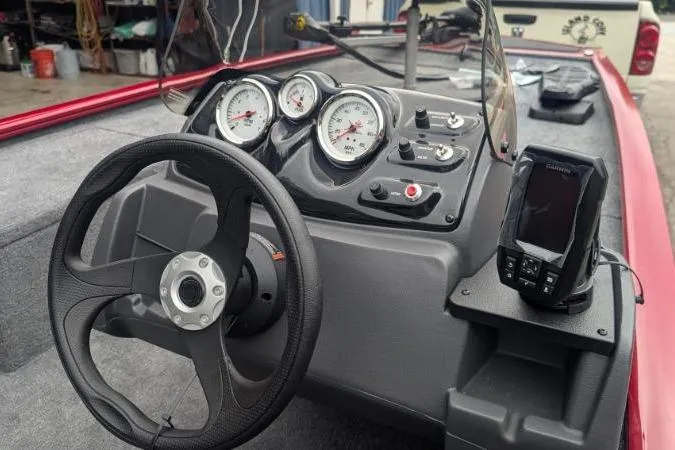 Slide: The Image of 2026 Tracker Pro 170 boat dashboard with steering wheel and gauges in a garage setting. - 2