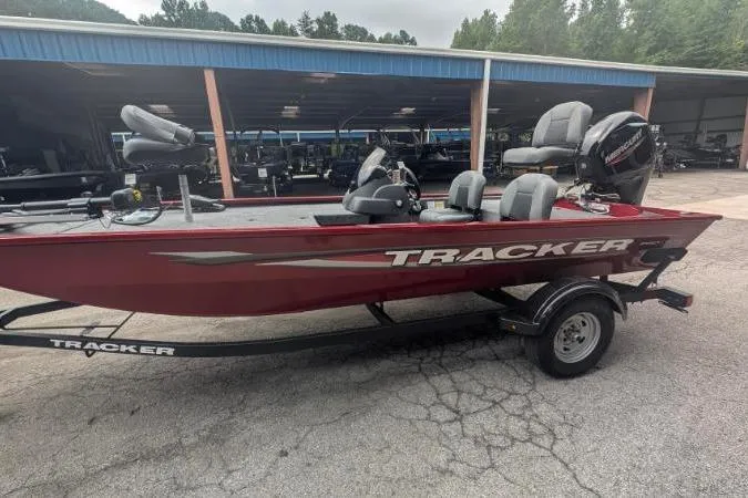 Slide: The Image of 2026 Tracker Pro 170 boat in red, parked on a trailer at a dealership. - 3
