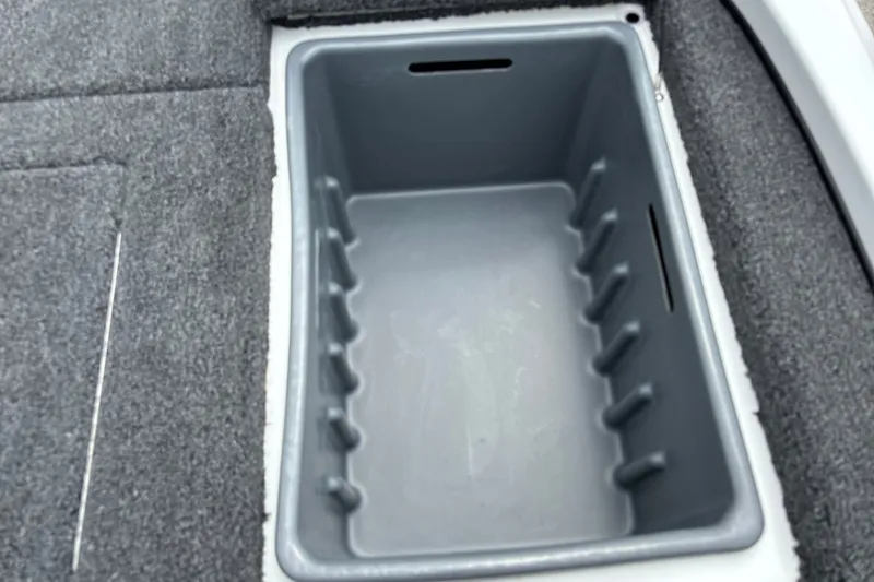 Slide: The Image of Storage compartment in 2026 Nitro Z17 boat, featuring gray interior and carpeted edges. - 22