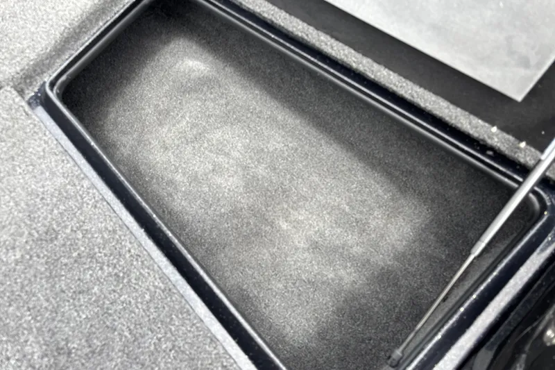 Slide: The Image of Storage compartment of a 2026 Nitro Z17 boat, featuring a carpeted interior. - 17