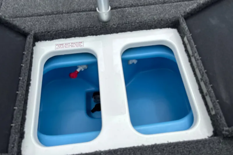 Slide: The Image of Livewell compartments in a 2026 Nitro Z17 boat, featuring dual blue interior basins. - 21