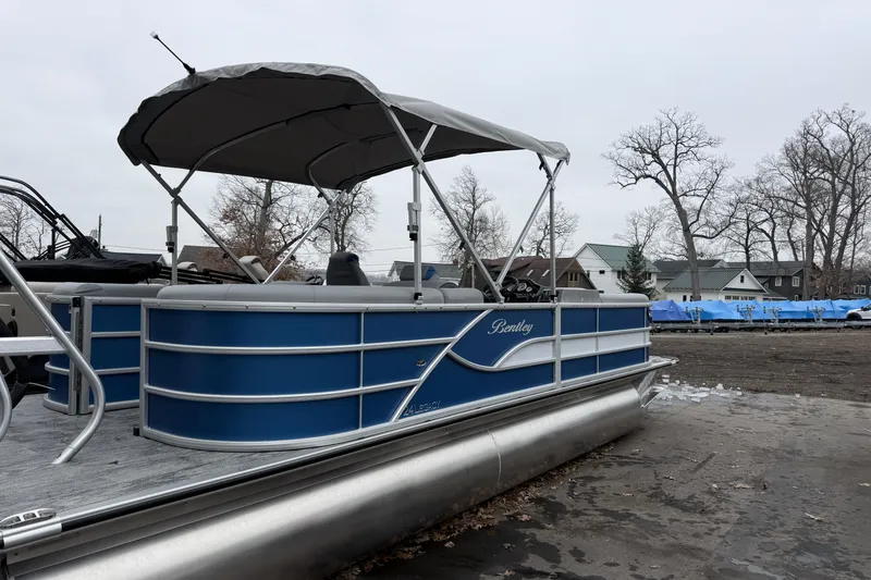 Slide: The Image of 2026 Bentley Pontoons Legacy 240 Navigator Ext on display, featuring blue exterior and canopy. - 3