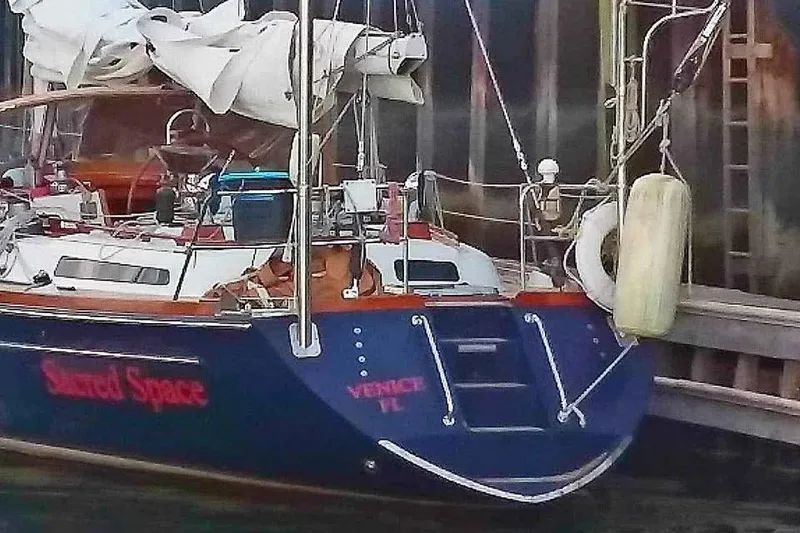 Slide: The Image of Sailboat "Shared Space" docked, Hans Christian Christina 1992 model, with folded sails. - 11