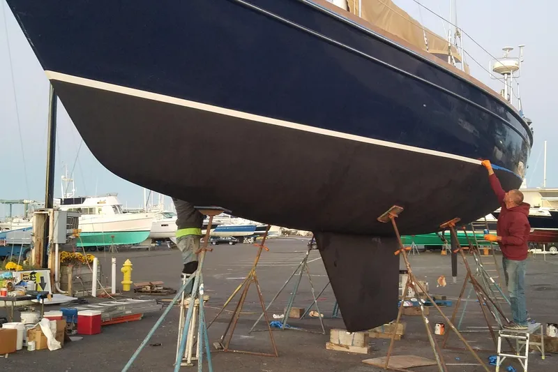 Slide: The Image of 1992 Hans Christian Christina sailboat undergoing maintenance in a boatyard. - 12