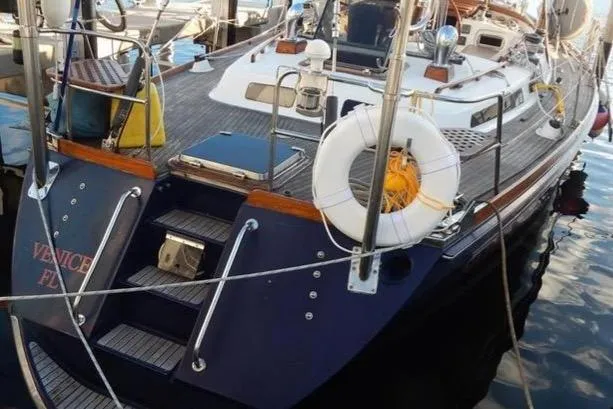 Slide: The Image of Sailboat docked at marina, Hans Christian Christina 1992 model, with life preserver and wooden deck. - 16
