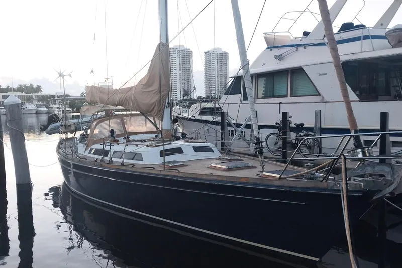 Slide: The Image of Sailboat docked at marina, Hans Christian Christina 1992 model, with cityscape background. - 17