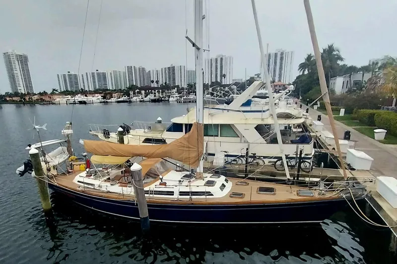 Slide: The Image of Sailboat docked in marina, Hans Christian Christina 1992, with city skyline in background. - 18