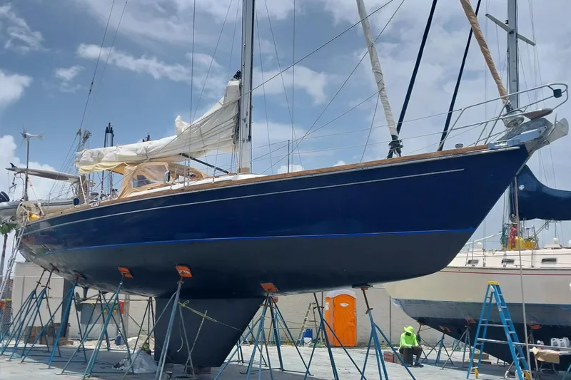 Slide: The Image of Sailboat "Christina" by Hans Christian, 1992 model, on dry dock under clear sky. - 19