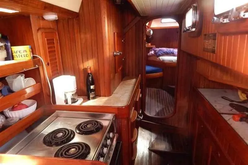Slide: The Image of Cozy 1992 Hans Christian Christina yacht interior with wooden kitchen and sleeping area. - 7