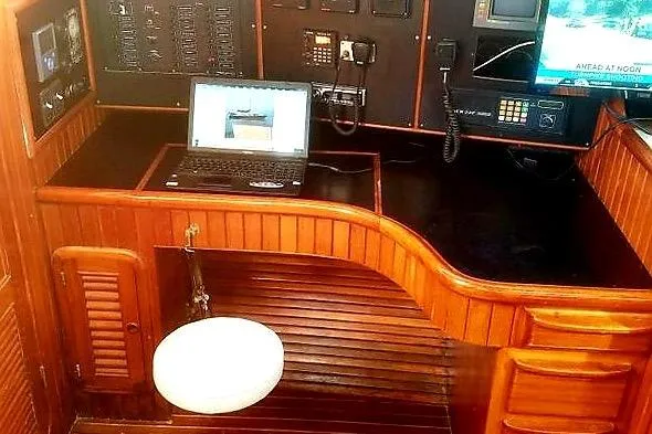 Slide: The Image of Navigation station on 1992 Hans Christian Christina yacht with laptop and control panels. - 8