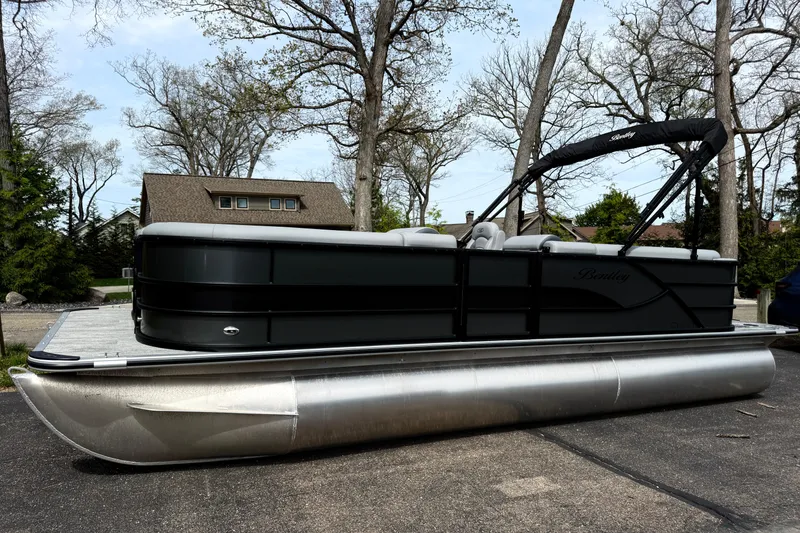 The Image of 2026 Bentley Pontoons Legacy 220 Cruise XL pontoon boat parked outdoors. - 0